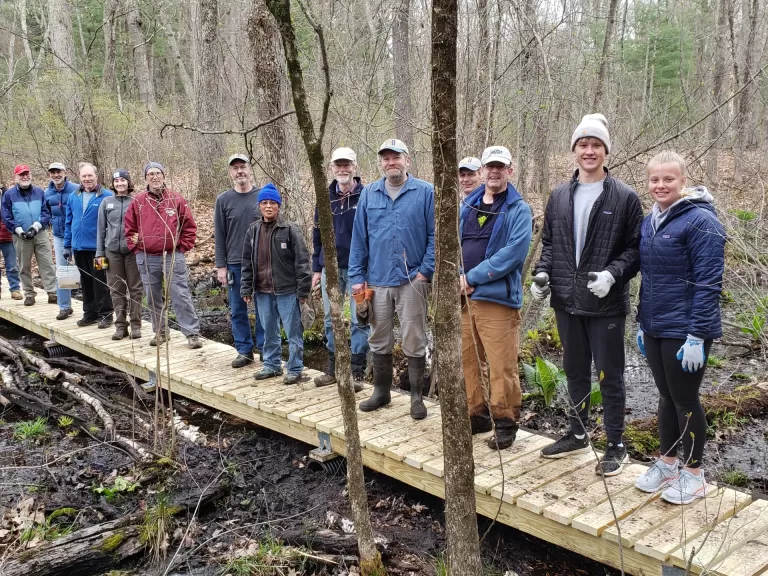 Volunteers stand atop the new boardwalk. Photo by Chris Menge.