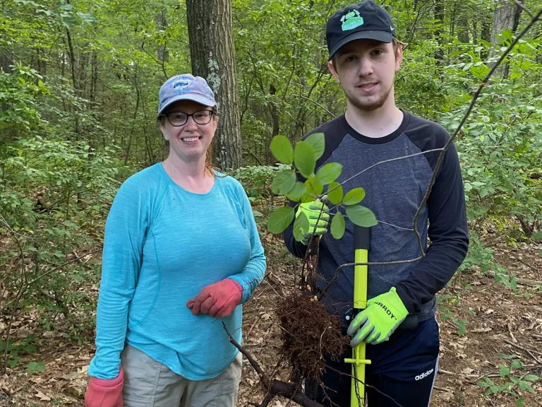 Aimee Powelka and Ethan Major with a weed wrench