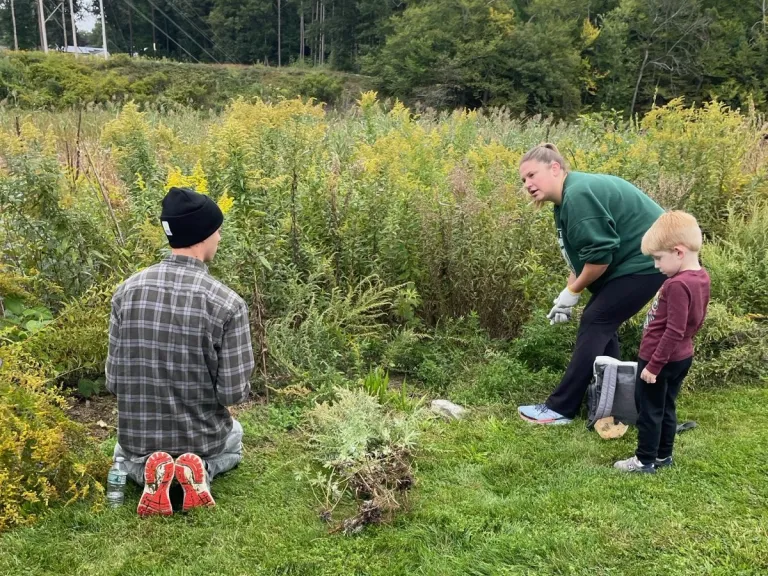 Chris Reardon (left) helped pull invasives from the pollinator garden on the Cochituate Rail Trail.