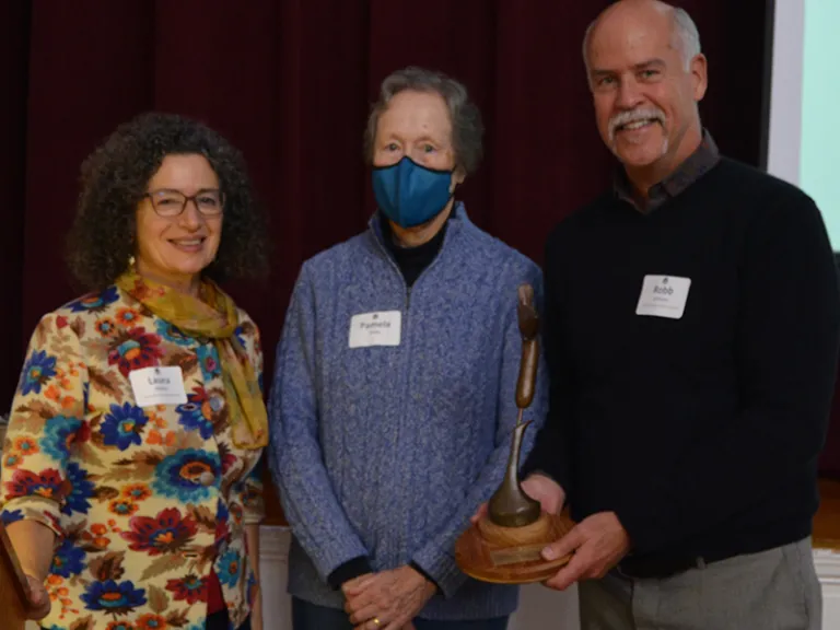 Laura Mattei and Pam Sway present Robb Johnson with the Lewis Conservation Award