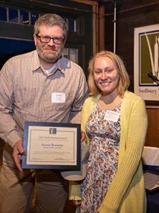 Dan Stimson presents the Youth Steward Award to Kristen Bestavros at SVT's 2022 Annual Meeting.