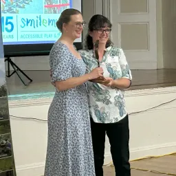 Cecil Hynds-Riddle presents the inaugural Trailblazer Award to Susan Brown, co-founder and Vice President of SMILE Mass.